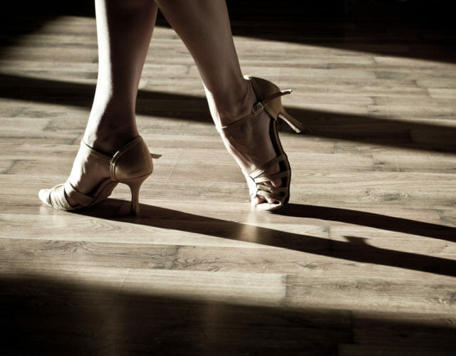 Female feet on the dance floor with ballrom shoes